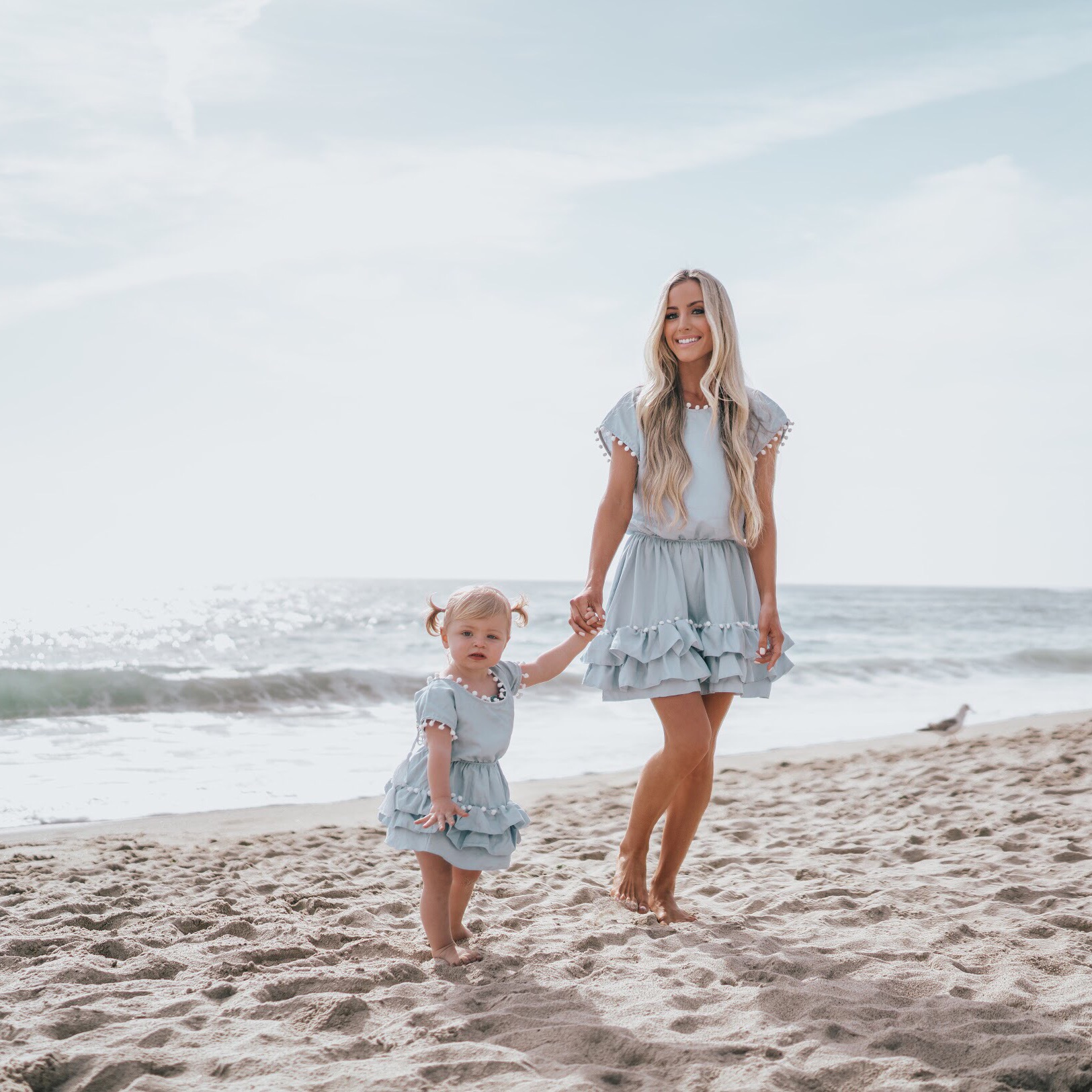 Lifestyle Blogger Katelyn Jones of A Touch of Pink Blog is wearing a Peixoto Nissi Pom Pom Dress from Shopbop